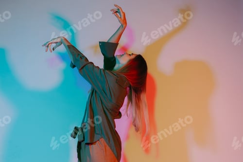 Preview: Woman expressing movement and emotion in colored light