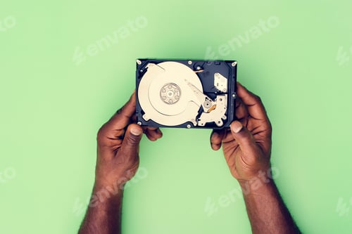 Preview: Hands holding Hard disk drive data backup isolated on background