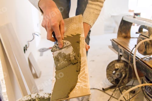 Preview: smear the tile repair in the house with a solution. Selective focus.