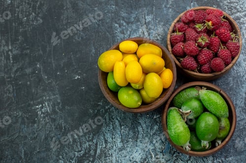 Preview: top view fresh red raspberries with green feijoas on light-grey background color berry fruit tree