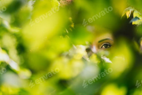 Preview: Nice portrait of beautiful afro woman through the leaves.