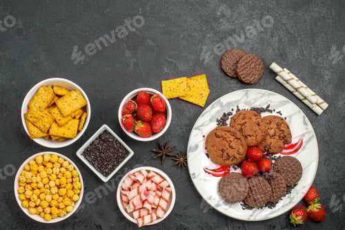 Preview: top view yummy choco biscuits with different snacks on dark desk sweet cookie tea