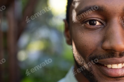 Preview: Smiling African American man enjoying nature outdoors, feeling relaxed and content
