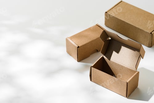 Preview: Open cardboard box on a reflective surface with soft shadows