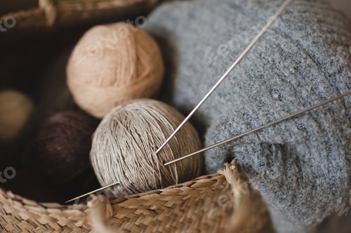 Preview: Knitting wool sweater close up. Skein of yarn with knitting needles.