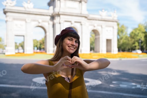 Preview: Woman making heart gesture at puerta de alcala