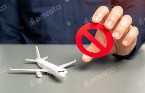 Preview: A man holds a prohibitory sign near an airplane. S