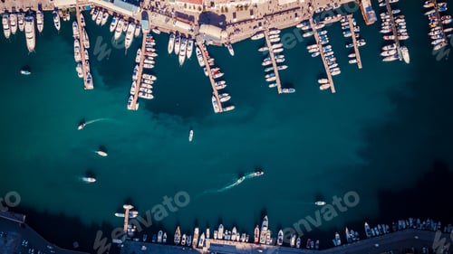 Preview: Aerial view of the bay with a lot of white boats and yachts at sunset on sunny day. View from above