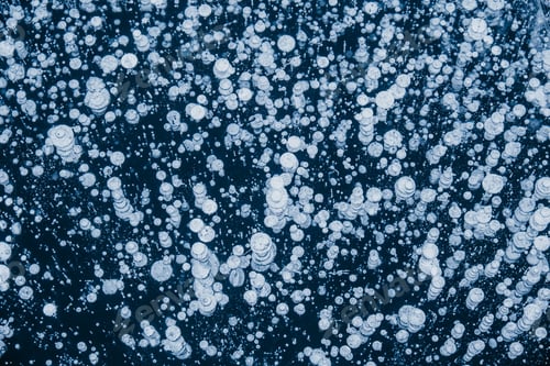 Preview: Baikal ice patterns. Frozen Lake Baikal with bubbles and cracks. Blue textured ice background.