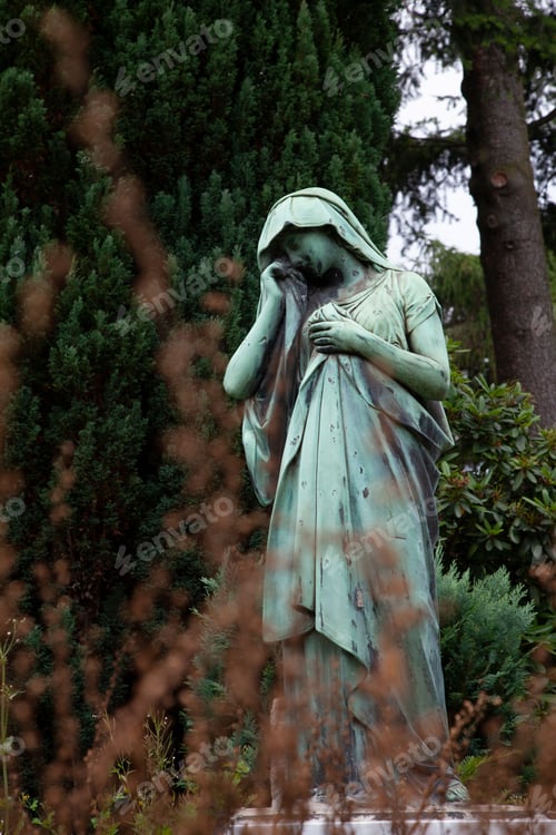 Preview: a statue of an old woman standing next to trees in a park