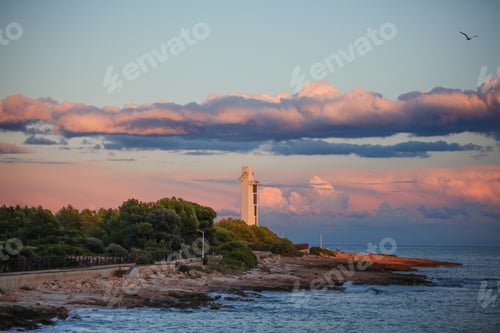 Preview: Beautiful view of a lighthouse by the sea at sunset in Alcossebre, Spain