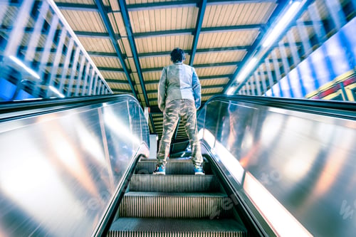 Preview: Man standing on treadmills escalator stairway with soft motion blur