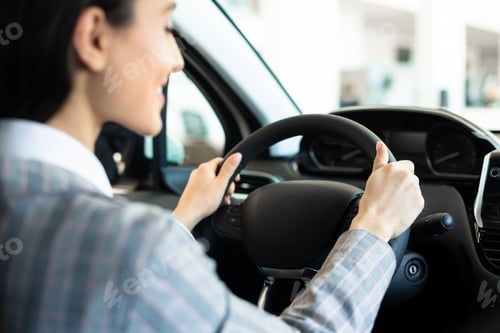 Preview: Young caucasian woman driving her new car