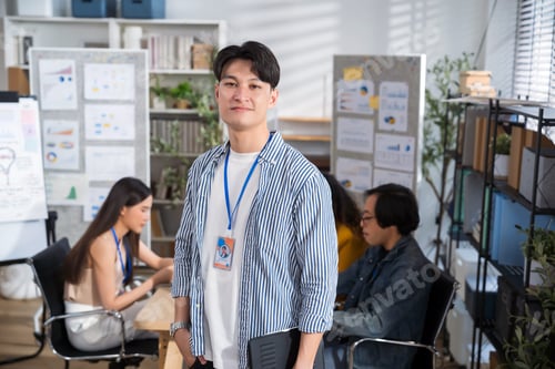 Preview: Portrait creative Asian businessman holding digital tablet laptop at at creative office workplace