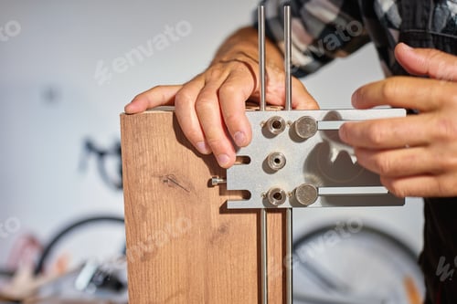 Preview: Carpenter using drilling jig tool to assemble wooden furniture