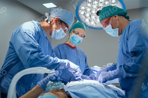 Preview: Team of surgeons performing operation at hospital