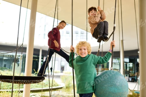 Preview: Joyful autumn playtime with friends enjoying the swings and climbing at a park