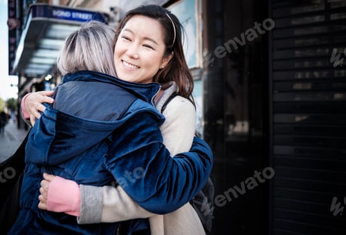 Preview: Multiracial mature women friends hug each other.