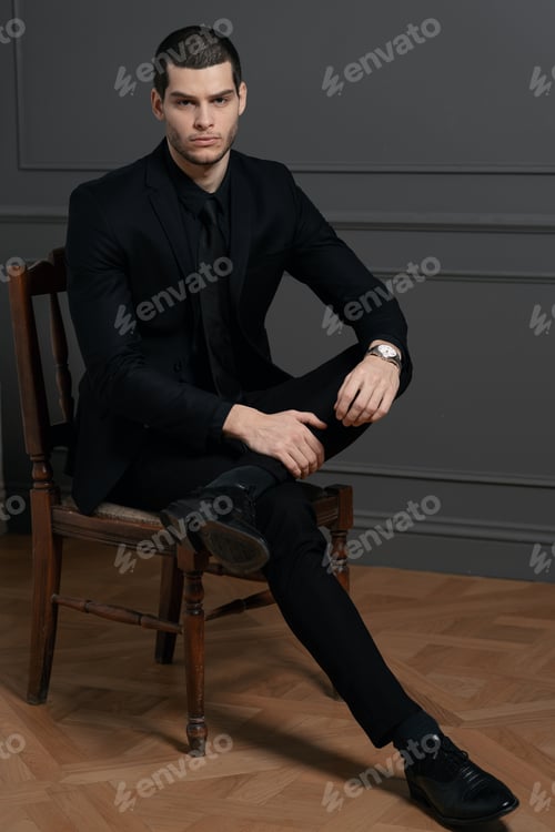 Preview: Young handsome businessman in black shirt and black suit