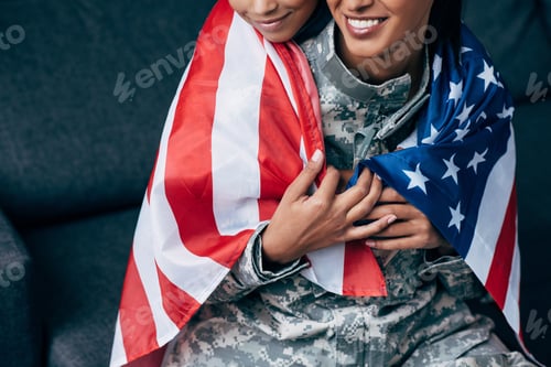 Preview: cropped view of african american daughter and female soldier in military uniform wrapped with