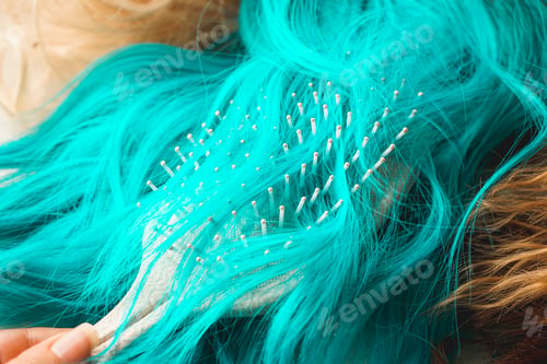 Preview: Close up of a brush brushing a colored wig