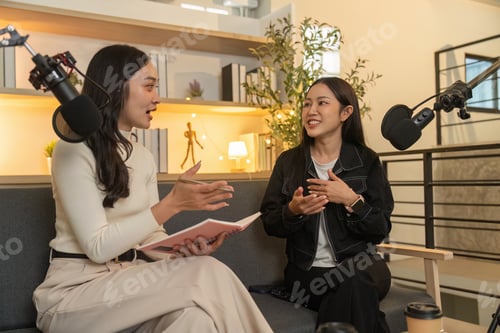 Preview: Podcast Interview. Two women discussing ideas while seated on a cozy couch.