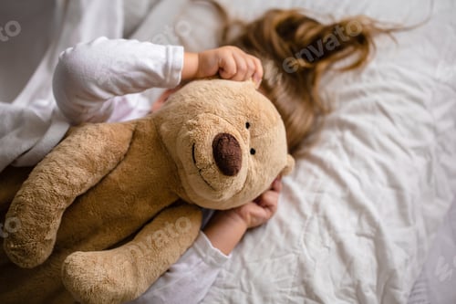Preview: little girl in bed with soft toy the emotions of a child