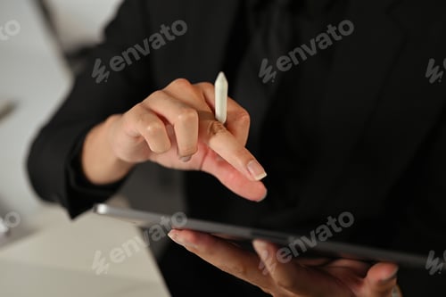 Preview: Close up shot of corporate worker interacting with tablet device in office