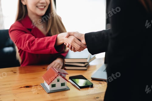 Preview: Estate agent and customer shaking hands after finished contract after about home insurance and