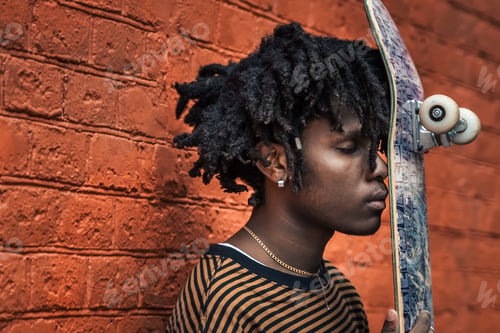 Preview: Portrait of young handsome stylish black man with natural hair dreadlocks. Afroamerican guy. Wall pa