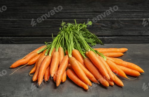 Preview: Ripe carrots on grey table. Healthy diet