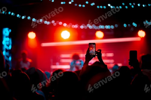 Preview: Person close up of recording video with smartphone during a concert