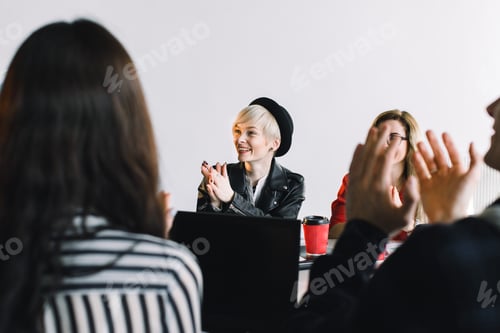 Preview: Creative agency meeting - group of business people in casual wear talking during conference at