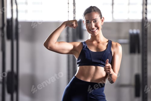 Preview: Strong, fit and thumbs up gesture of a successful woman in a healthy muscular body at a gym. Portra