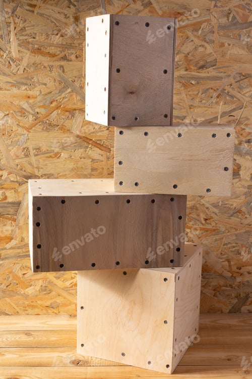 Preview: Wooden cube or plywood box block near wall background texture. Abstract construction concept