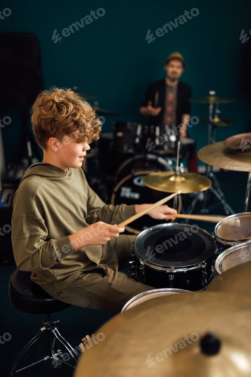 Preview: Boy at music school learning to play drums.