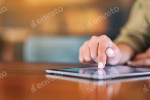 Preview: Closeup image of a woman pointing finger at tablet pc on wooden table