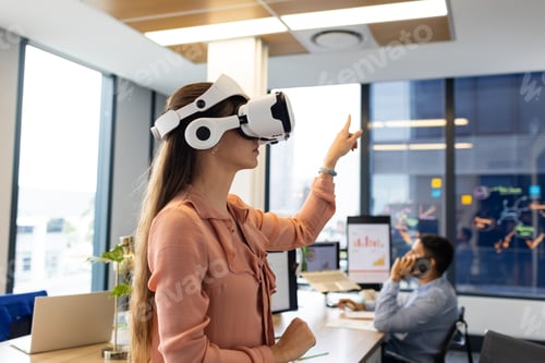 Preview: Using VR headset, woman interacting with virtual environment in modern office