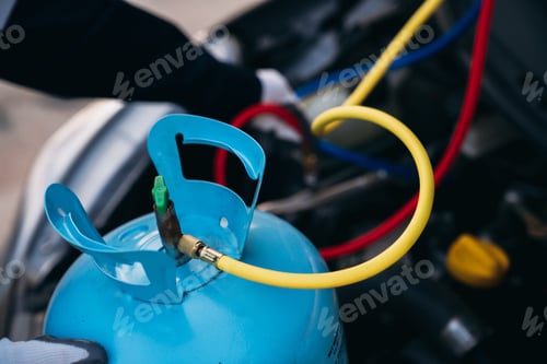 Preview: Close up hand of Mechanics inspect and check the refrigerant and fill the car air conditioner.