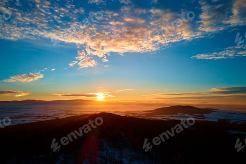 Preview: Sunset over mountains covered with forest