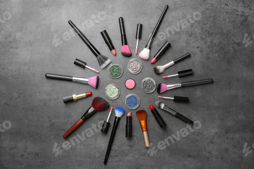 Preview: Flat lay composition with cosmetic products and makeup brushes on grey background