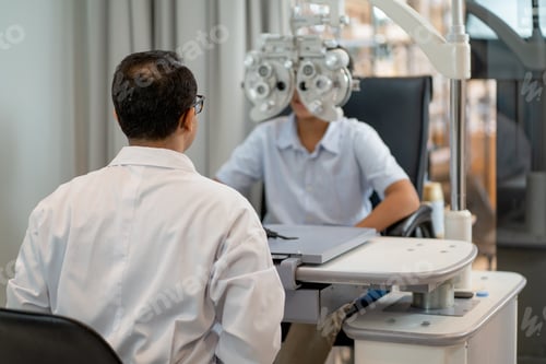 Preview: Back of optical staff prepare and use machine for processing of eyecare for children