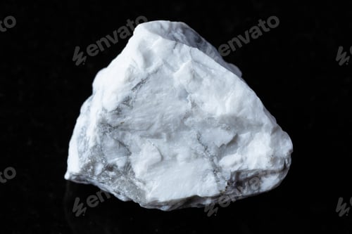 Preview: sample of raw howlite rock on black granite
