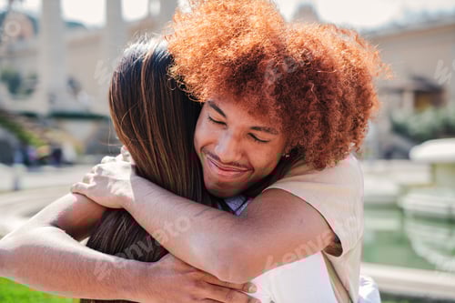 Preview: close up portrait of teenage joyful couple embracing together. One african american young guy with