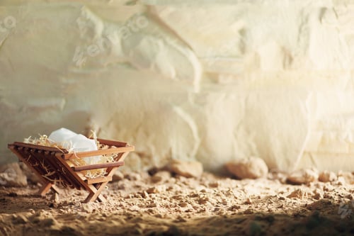Preview: Christian Christmas concept. Birth of Jesus Christ. Wooden manger in cave background. Banner, copy