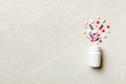 Preview: Pills and Capsules Spilled From a Bottle