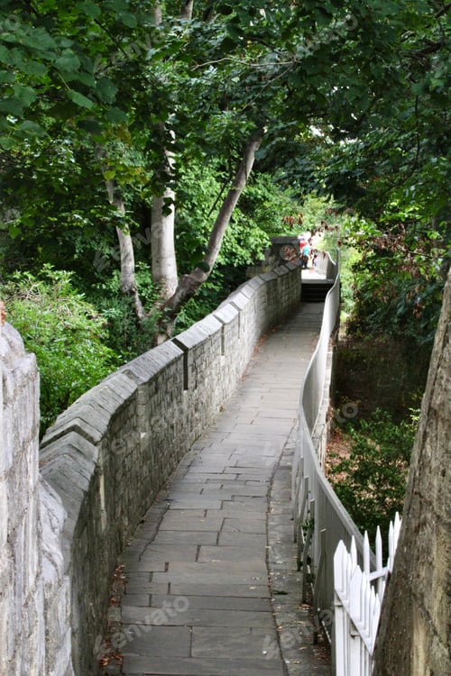 Preview: Pathway winds its way through a lush green landscape. York, England, UK.