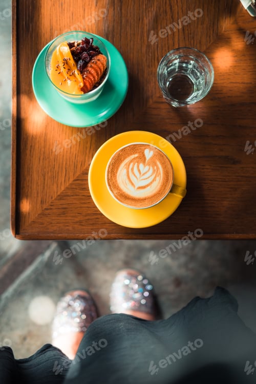 Preview: Woman taking overhead photo of her breakfast