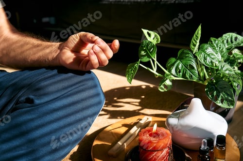 Preview: Overweight man practicing yoga and meditation at home sitting in lotus pose on yoga mat.