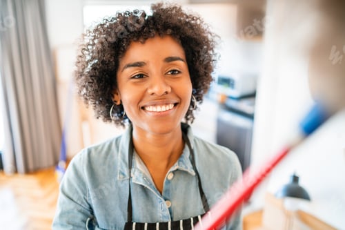Preview: Afro woman dusting her new house.